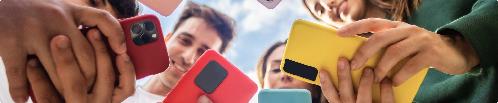 Group of people holding colorful smartphones, emphasizing mobile connectivity and communication solutions relevant to GBIS Communications' business services.