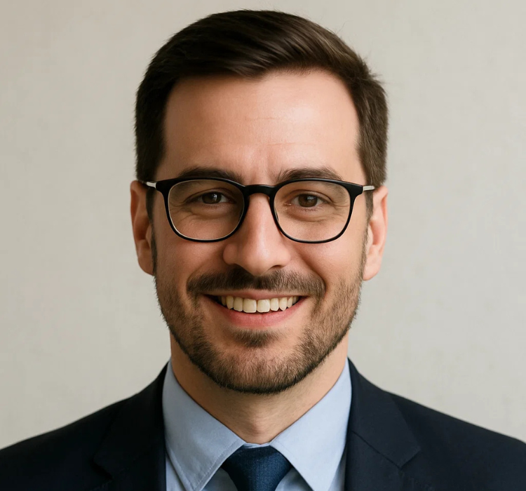 Smiling professional man in glasses wearing a suit, representing GBIS Communications' commitment to reliable business connectivity solutions.